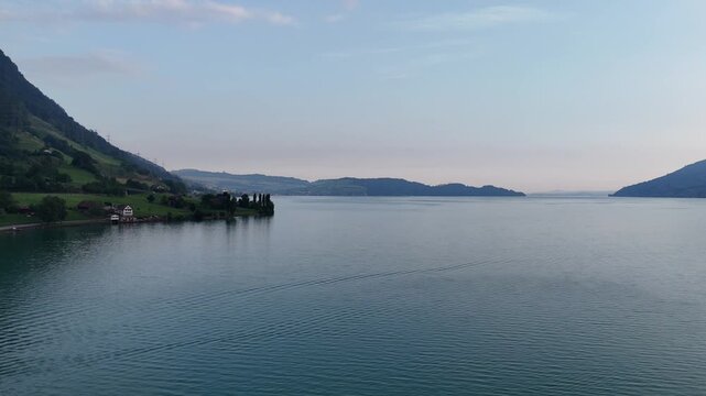 Panorama flight over Lake Zug (Zugersee) with mountains in canton of Schwyz in Switzerland
