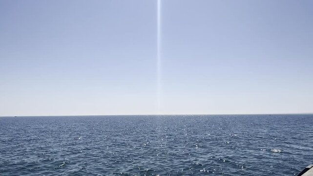 Serene vast blue ocean horizon with sunny light beam. Calming nature background for mental health, mindfulness meditation and stress relief. Sustainable marine ecology and water conservation
