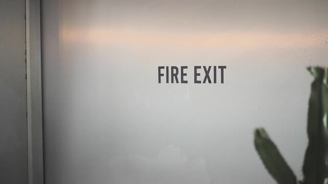 Safety sign shows fire exit instruction in building
