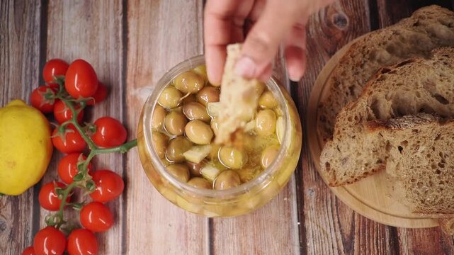 Enjoying olives with bread and fresh tomatoes