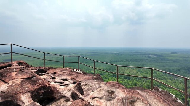 POV walking on smooth red sandstone toward scenic viewpoint at Three Whale Rock, Bueng Kan, Thailand