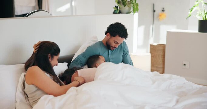 Happy family, playing and bed with children in home for fun holiday, weekend or bonding together. Mom, dad and tickle with kids or duvet sheet in bedroom for laugh, humor or funny childhood in house