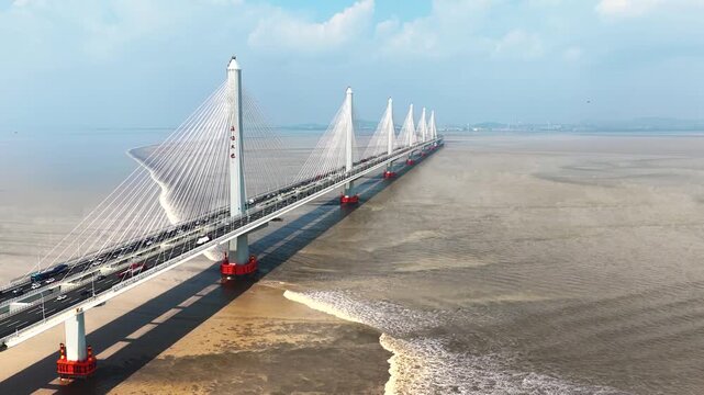 The rising tide is coming to the Jia-Shao Bridge over the Hangzhou bay. It is one of the most spectacular, natural phenomena about Qiantang River in China
