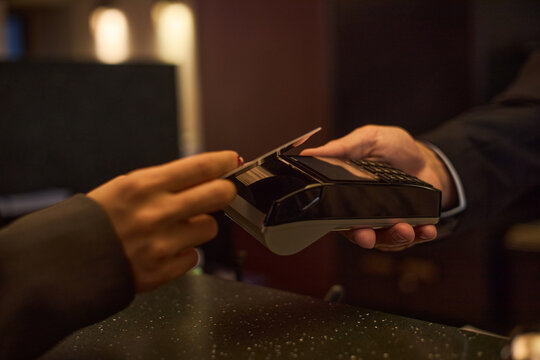 Close up of customer paying with credit card on payment terminal, completing contactless retail transaction for checkout, hospitality service, fintech or cashless commerce
