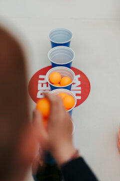 Blue plastic cups and orange ping pong balls for beer pong.