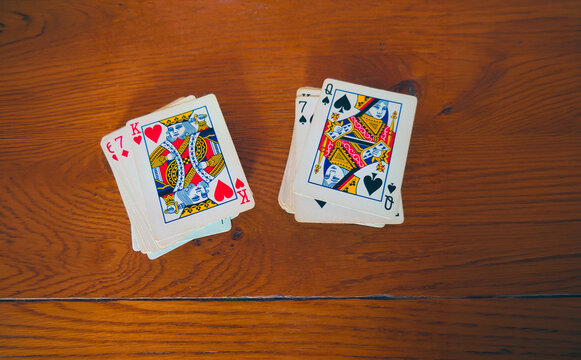 King of Hearts/Queen of Spades - interracial game of love; cards stacked against 