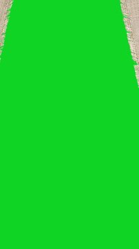 Vertical torn canvas fabric texture split space revealing animated on a green screen chroma key background. It gives a high quality professional template design element for video compositing