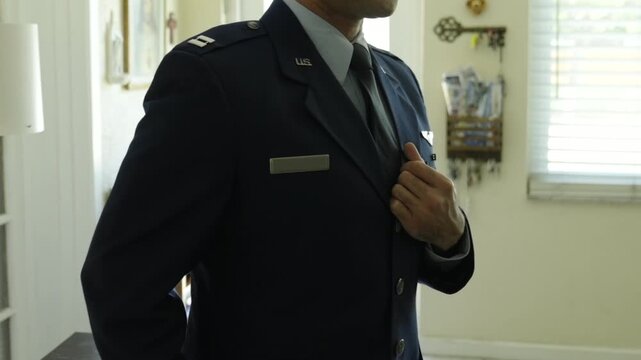 Uniformed Air Force Officer getting dressed Before Formal Ceremony