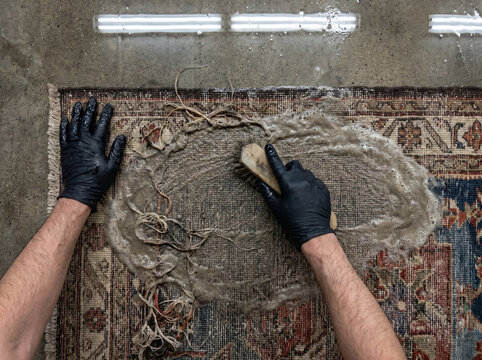 Georgian sumakh kilim turned face-down on wash floor exposing loose thread floats on reverse side worked by hands