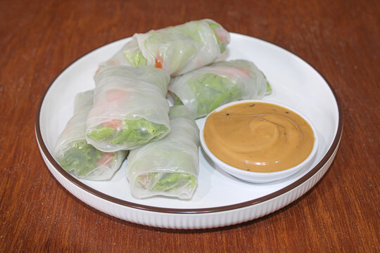 Fresh Vietnamese spring rolls with peanut dipping sauce on plate