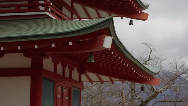 Chureito Pagoda red curved roofs with hanging bells in Fujiyoshida Japan