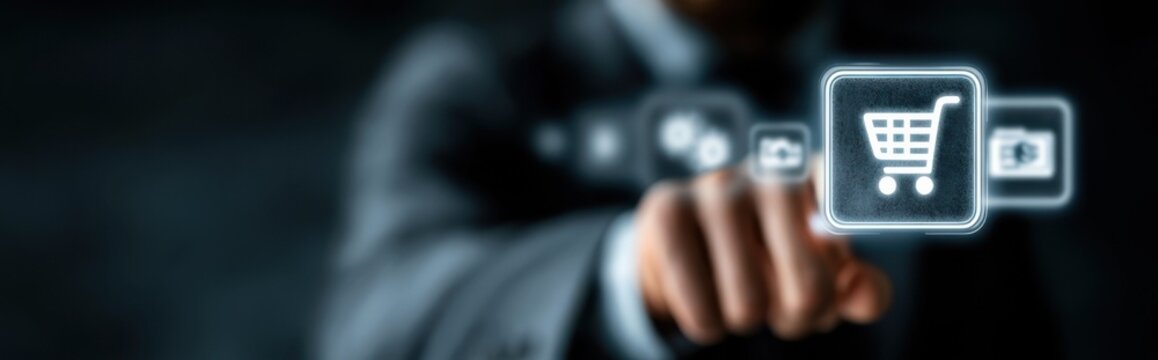 Man points at digital shopping cart icon during online shopping in office setting at night
