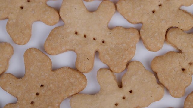 Golden shortbread bear pattern. Baked cookies with crumbly texture and features. Close up view showcasing textured shortbread cookies with detailed features and soft lighting
