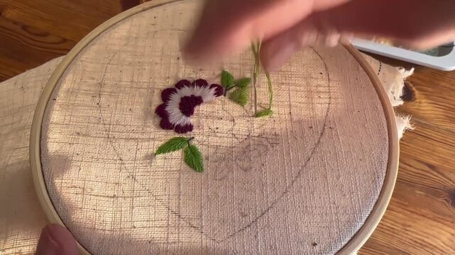 Macro close up of embroidery stitches on fabric, green tread, aesthetic macro embroidery process in cozy natural light