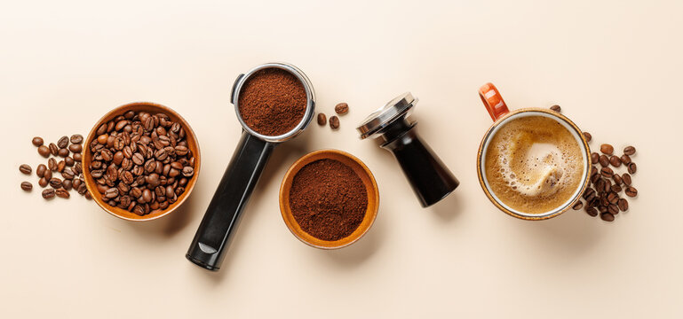 Coffee accessories and espresso tools on light beige background