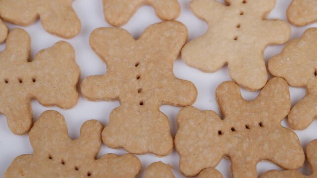 Homemade bearshaped cookies closeup flatlay, golden shortbread biscuits overlapped, tiny fork perforations, warm neutral tones, minimalist bakery vibe, cozy home kitchen batch