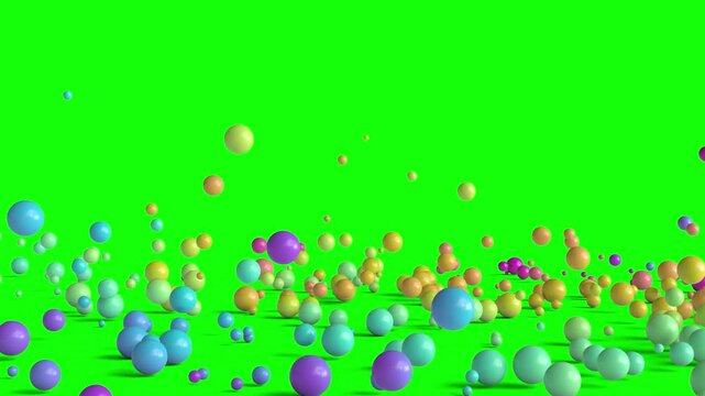 colorful spheres falling and bouncing on a green screen 3d