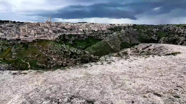 Time warp walking POV in the Murgia Materana Park overlooking the city of Matera during a cloudy day. The video was shot in Basilicata, Southern Italy