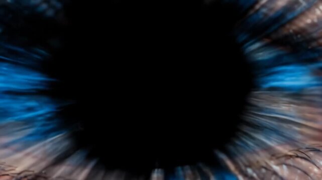 Close-up of a human eye with striking blue iris and detailed eyelashes, showcasing the intricate patterns and textures of the eye in a well-lit environment