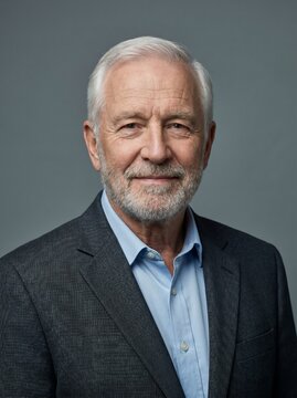 Smiling Senior Man Portrait with White Hair and Beard in Business Suit
