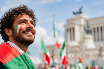 Man with Italian flag face paint celebrating Republic Day in Rome looking up.