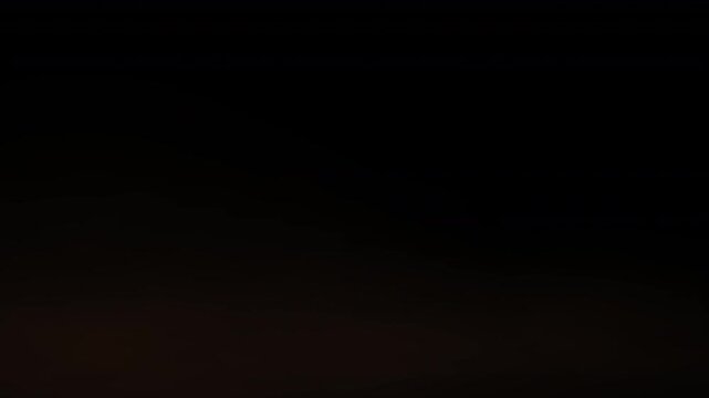 very thin subtle layer of smoke, fog or haze with a very pale subtle light pinkish hue blowing like a thin veil of cloud or mist along the low lying surface or floor 4K animated rolling fog effect