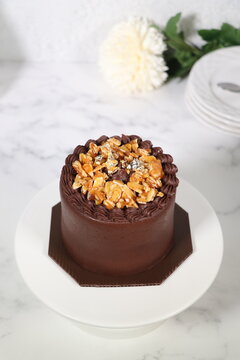 Rich chocolate cream coated cake topped with caramel glaze, nice angle view.