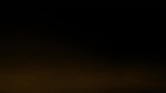 low lying sand storm dust or smoke, blowing quickly across a surface, rusty dusty debris in a smoky orange sulphur like fast moving gas 4K animation to create a brown mist or fog
