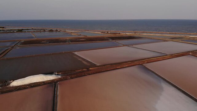 Aerial view of salt harvesting ponds over coastal Thailand, crystal salt ponds.