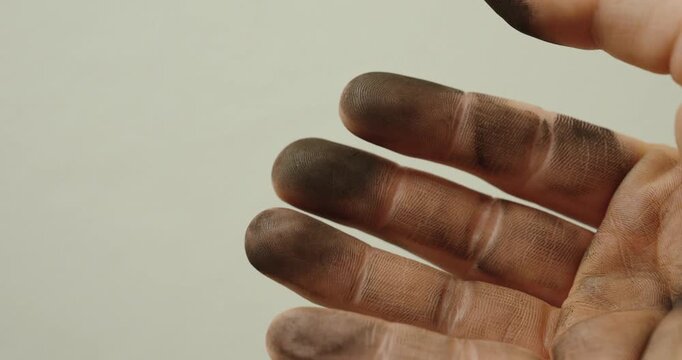 Close-up of dirty fingers covered in grime and dust. Visual representation of manual labor, hard work, industrial environment, and real-life working conditions.