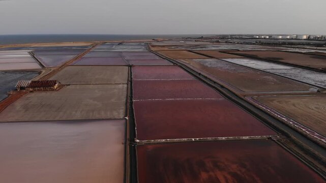 Aerial view of salt harvesting ponds over coastal Thailand, crystal salt ponds.
