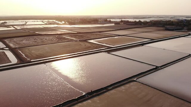Aerial view of salt harvesting ponds over coastal Thailand, crystal salt ponds.