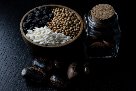 Still life of dried legumes such as lentils, devil's beans and black chickpeas with rice 02.26
