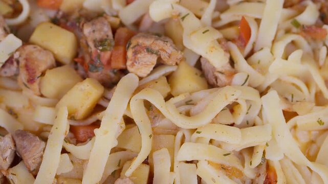 Rich flavorful noodles with tender meat and vegetables. Comforting bowl of handpulled lagman noodles featuring stewed meat and fresh vegetables in seasoned broth