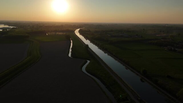 Po River and Naviglio di Cremona in Cremona Lombardy Italy define irrigation network across Po Valley farmland supporting crop production and agribusiness landscape, static aerial shot