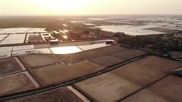Aerial view of salt harvesting ponds over coastal Thailand, crystal salt ponds.