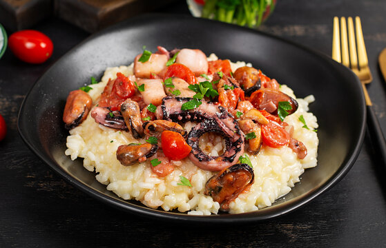 Seafood Risotto with Octopus and Mussels on Dark Background