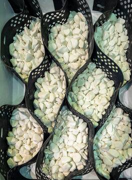 Geocell Cellular Confinement System Filled with White Decorative Stones for Erosion Control and Landscaping