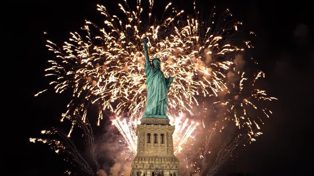 The statue of liberty with fireworks exploding in the night sky