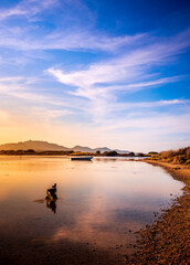 Fototapeta premium Fishermen''s boats in a bay in the sunset