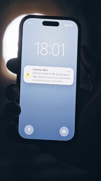 Vertical video. Smartphone Showing Extreme Emergency Alert Inside Dark Tunnel With Bright Light Background, Cinematic Crisis Scene About Immediate Danger and Survival