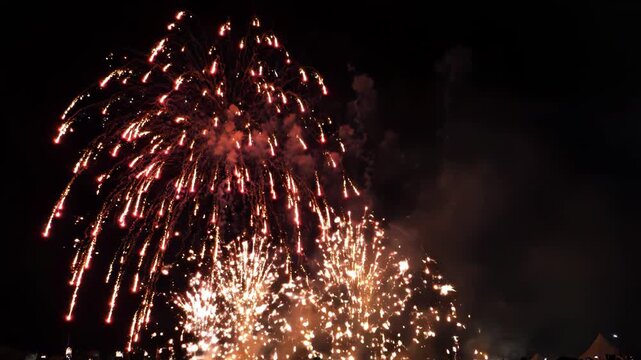Vibrant fireworks exploding in the night sky with colorful sparks and smoke