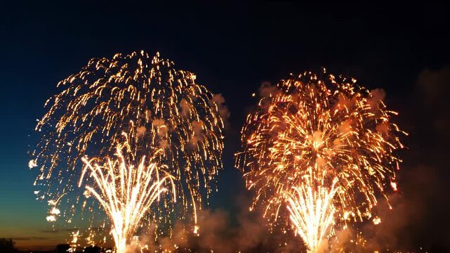 Vibrant fireworks exploding in the night sky with smoke and colorful lights