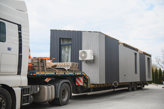 Modular prefab house being transported on a flatbed trailer