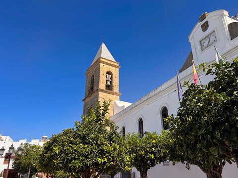 bell tower of the catholic church Parroquia De Santa Catalina Casa Parroquial in the old town of Conil de la Frontera, Cadiz, Andalusia, Spain