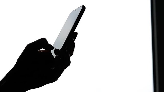 Silhouette of hand holding smartphone perfect for IT presentations and tech marketing