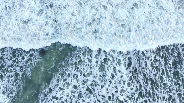 Overhead ocean foam pattern on moving waves