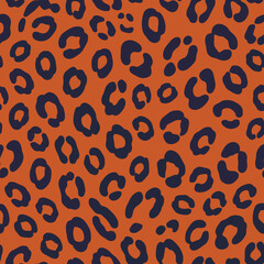 Obraz premium Seamless Pattern Of Dark Blue Leopard Spots On A Rust Orange Background leopard print animal print
