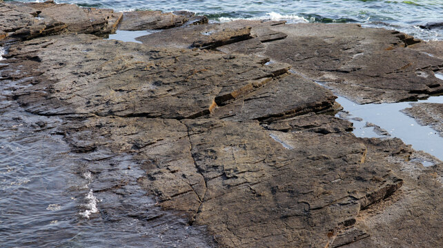 Prehistoric Earth Formation: Layered Sedimentary Rock and Ancient Coastal Geology