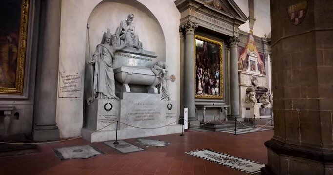 Ascending shot inside Santa Croce in Florence, Italy, highlighting the monumental cenotaph of Dante Alighieri, inaugurated in 1830 to honor the author of the Divine Comedy.